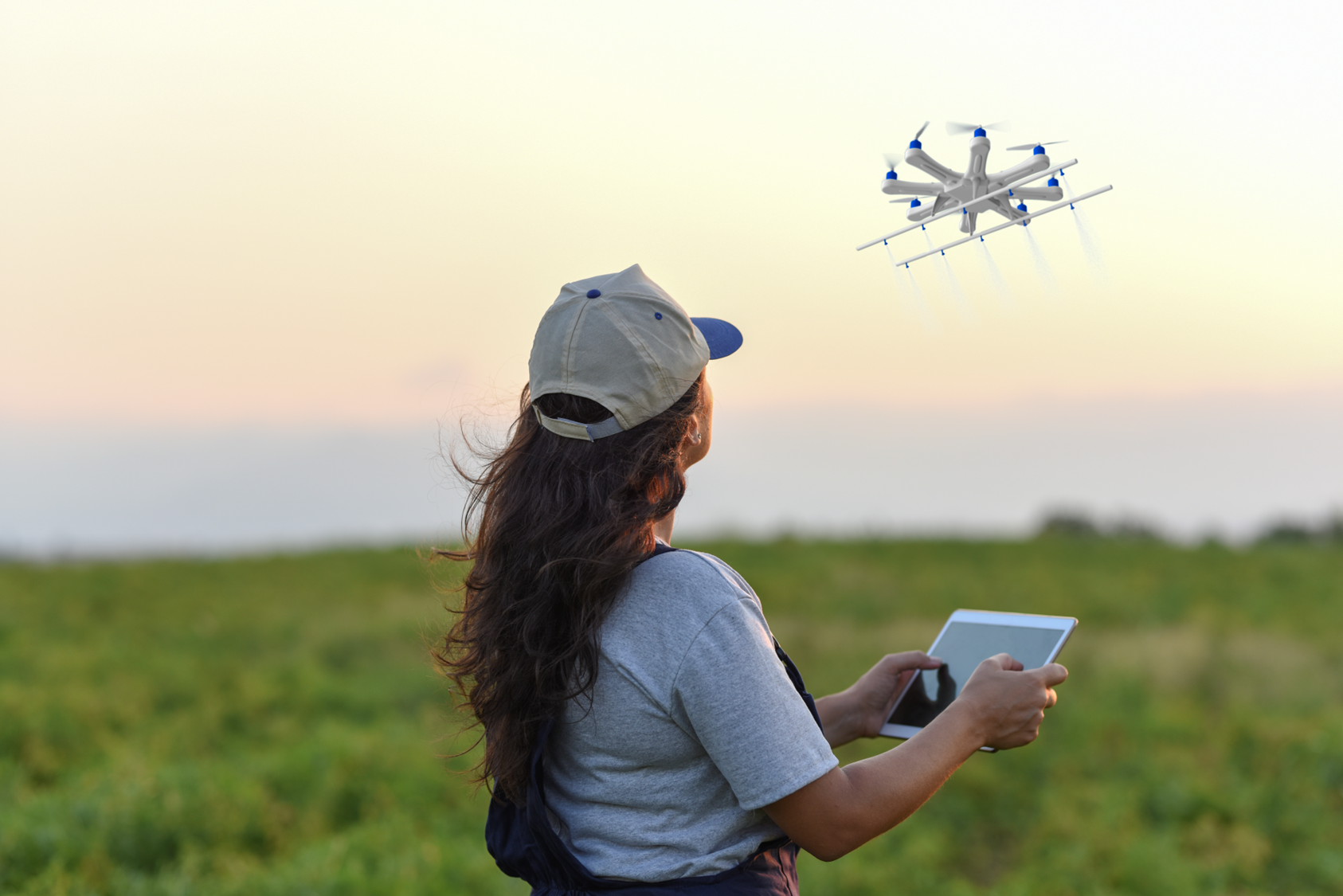 Researcher piloting an agricultural drone over a field at dusk
